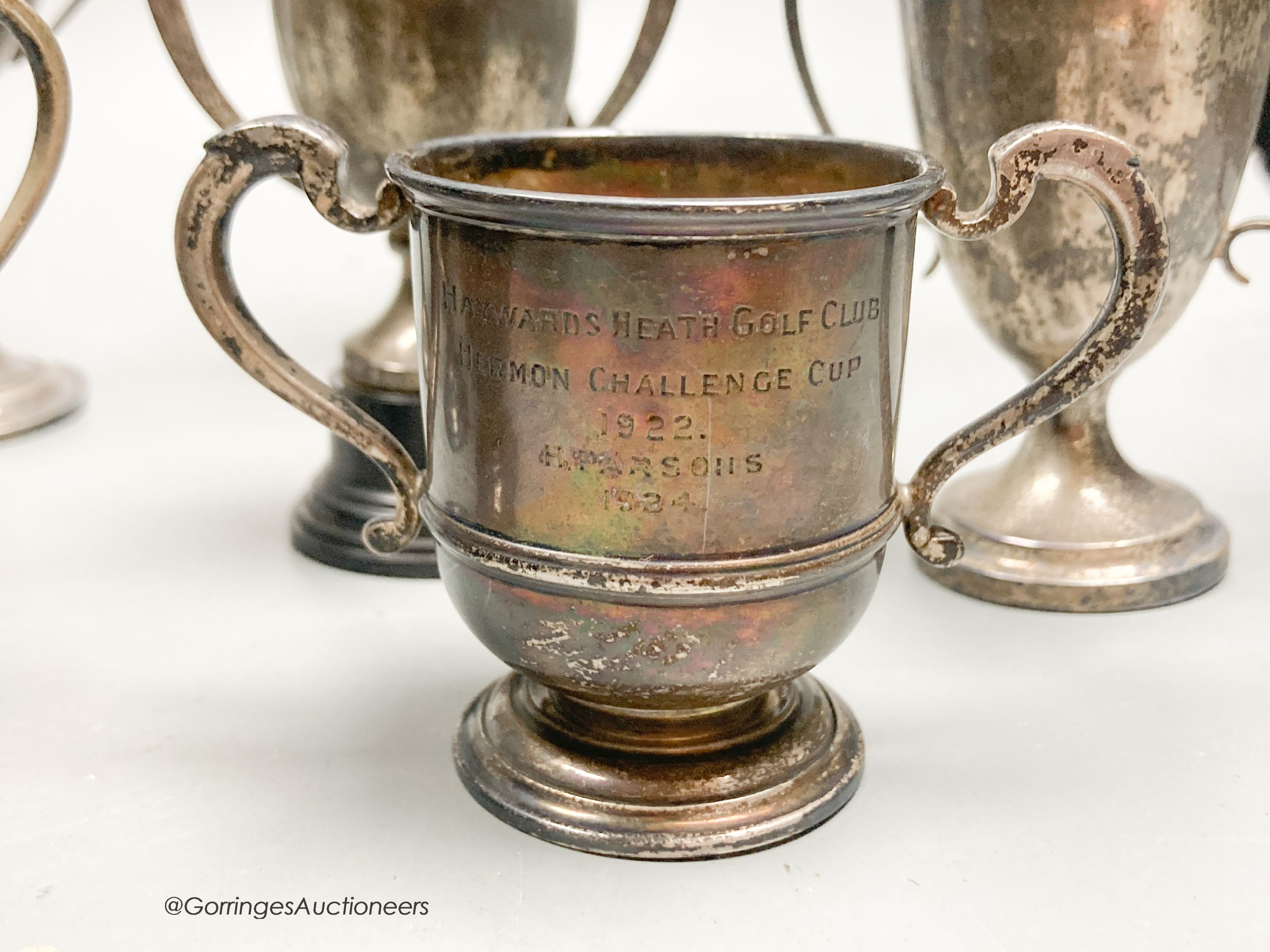 Eight assorted small silver trophy cups and one plated cup, tallest 11.3cm, 11.5oz.